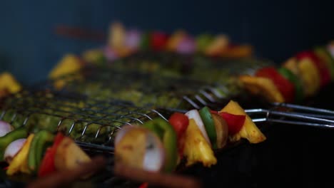 Close-up-of-hand-spraying-water-on-barbecue