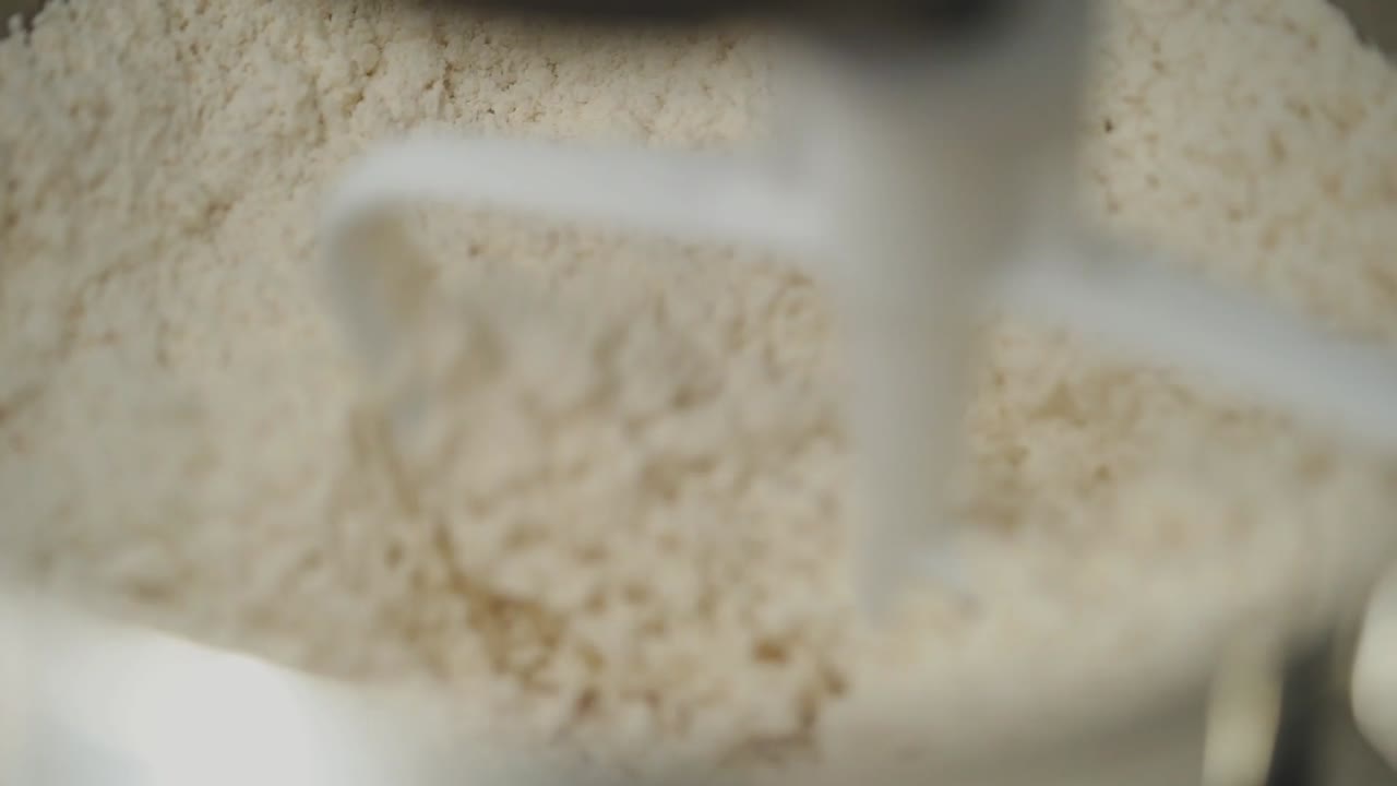 Mixing dough using a kitchen machine slow motion  hand held