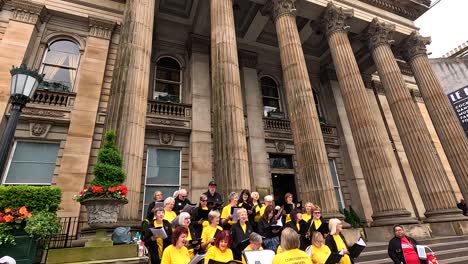 choir singing outside historic building in edinburgh