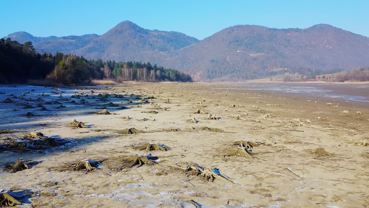 Dolly out shot of a deforested area in dry Zovnek lake bed near Braslovce, Slovenia