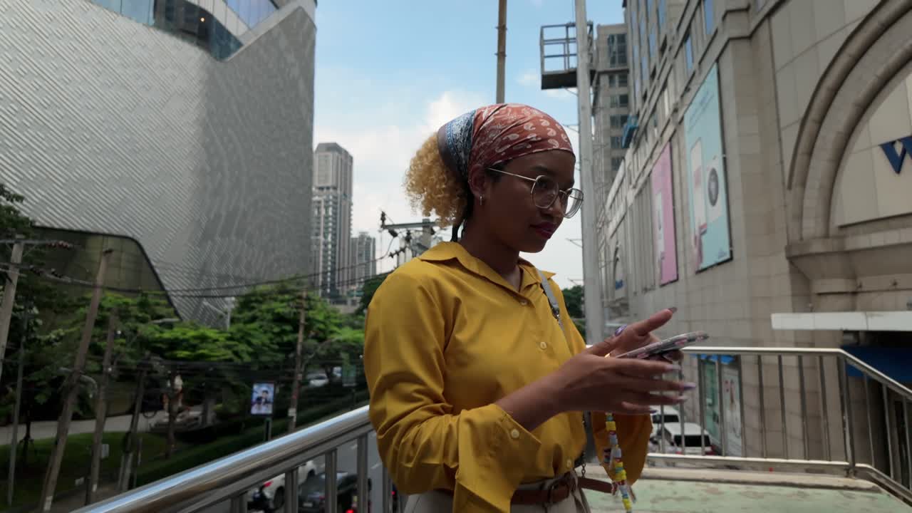 Woman using phone in a city