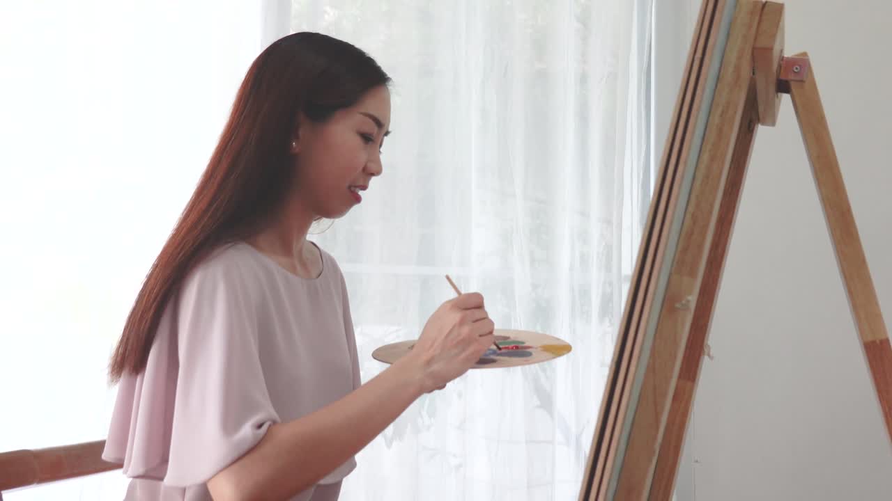 그녀의 취미로 우리 집에서 오일 페인트로 캔버스에 그림을 그리는 여자 여성 예술가