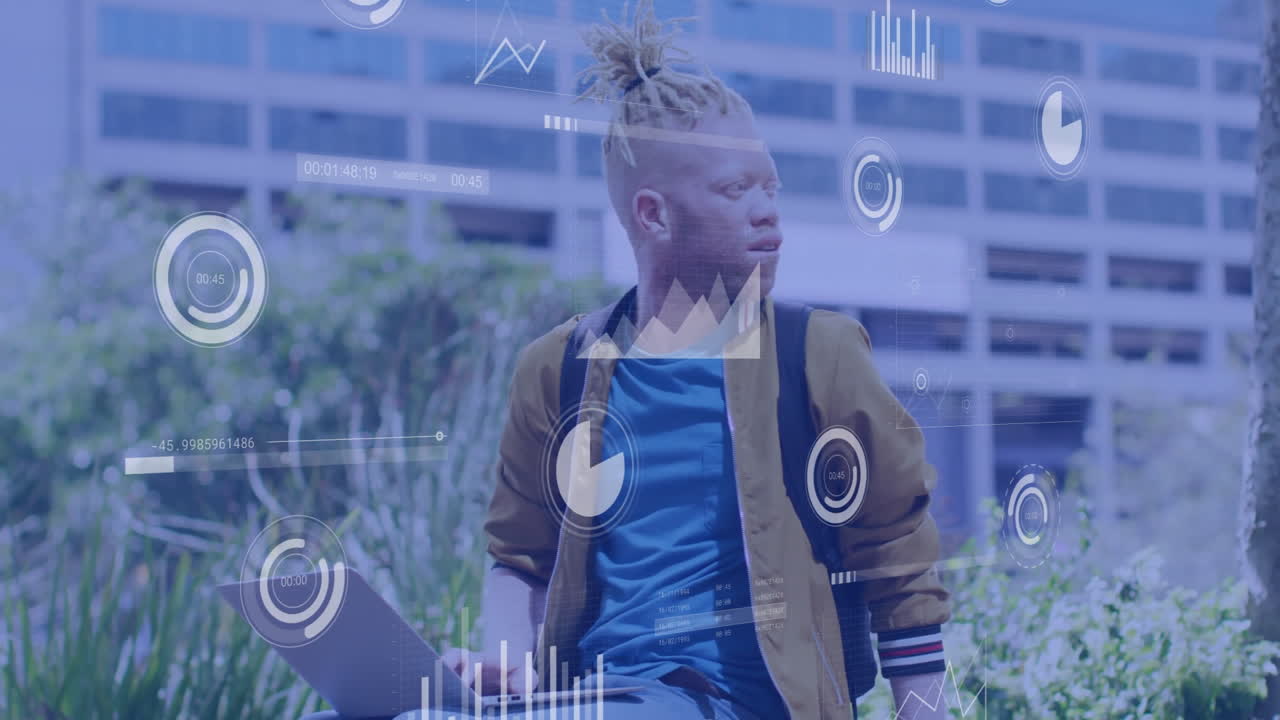 Charts and graphs animation over person with laptop in urban outdoor setting
