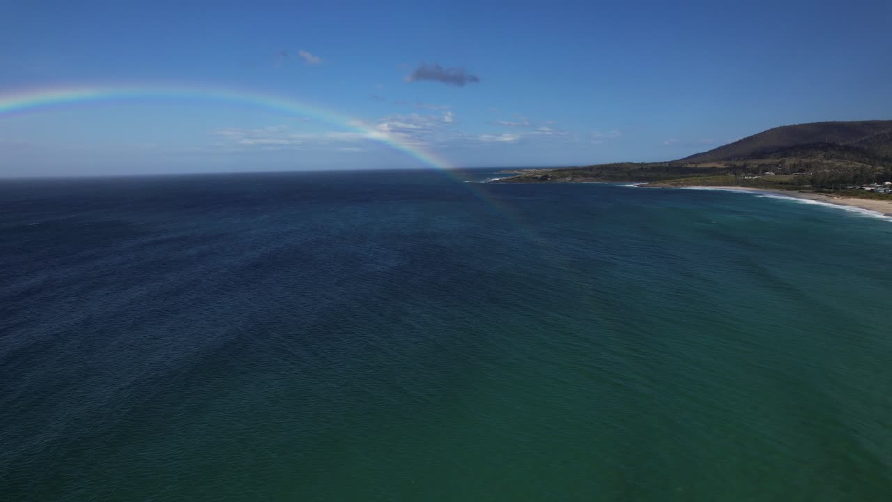 Bay Of Fires With Rainbow Over Seascape In Tasmania, Australia - Aerial Drone Shot