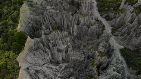 out of this world - aerial reveal of river valley surounded by eroded rock pillars