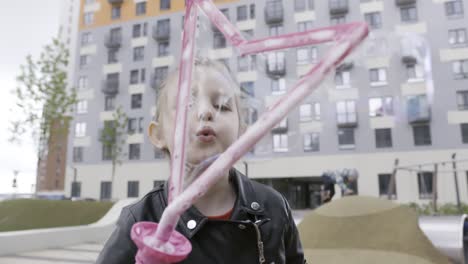 child blowing bubbles in a park