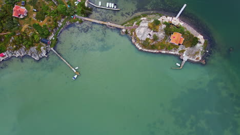 Wonderful View Of The Beautiful Island In Rörtången, Sweden With Turquoise Water and Green Trees - Aerial Shot