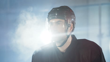 close up of a concentrated male hockey player looking at the camera and breathing in cold air on the ice arena 1