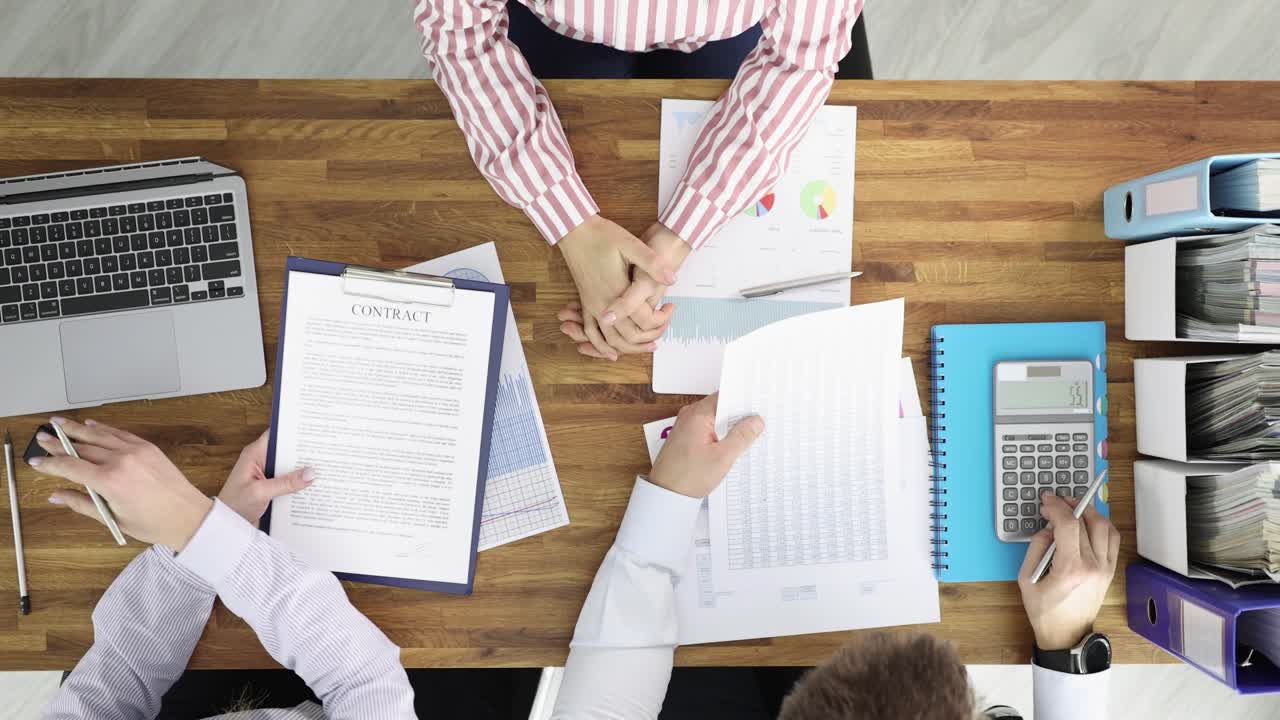 Business meeting with contract and financial documents