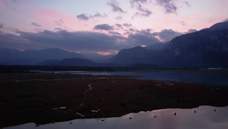 aerial-stunning-sunset-in-Canadian-amazing-natural-mountains-landscape-drone-fly-above-Squamish-Spit-conservation-area