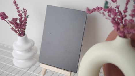 blank canvas display with flowers and vases