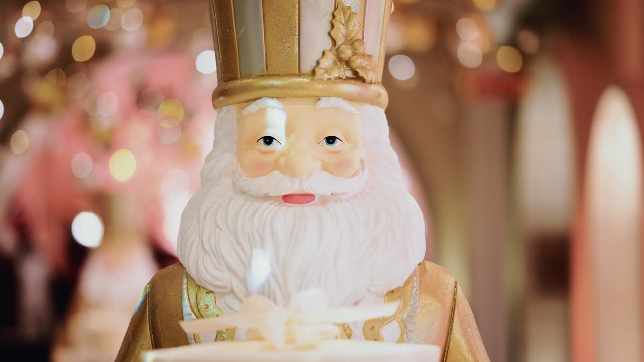 Close up of a Santa Claus figure inside a festive Christmas installation with warm lights and ornaments