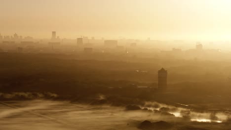 sunrise over a city covered in fog