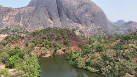 aerial - rising reveal wide shot of an inselberg rock