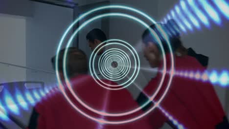 animation of circles pulsating over diverse female and male medics pulling bed with patient