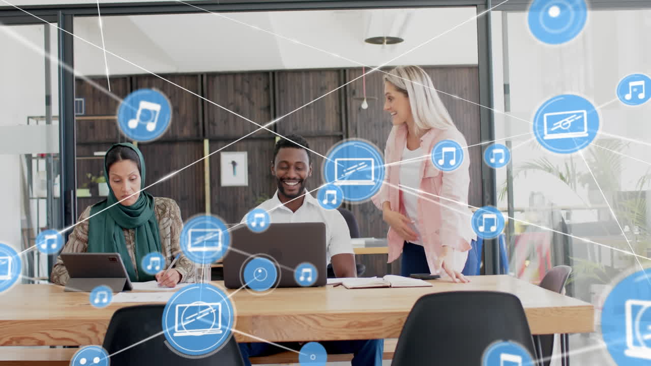 Animation of network of digital icons against diverse colleagues discussing together at office