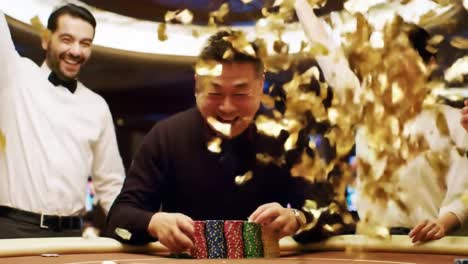 a joyous moment at the casino: celebrating victory and friendship with laughter, chips, and drinks in a glamorous poker atmosphere