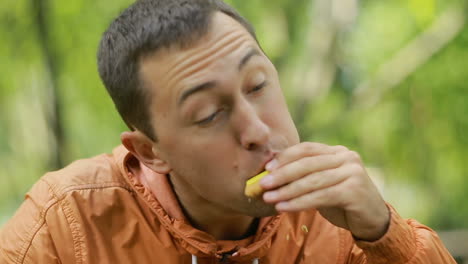 hungry man eating cookies. young man completely eating cookies in nature