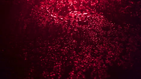 shooting of wet drops on red background