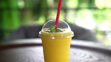 fresh mango smoothies glass in cafe restaurant