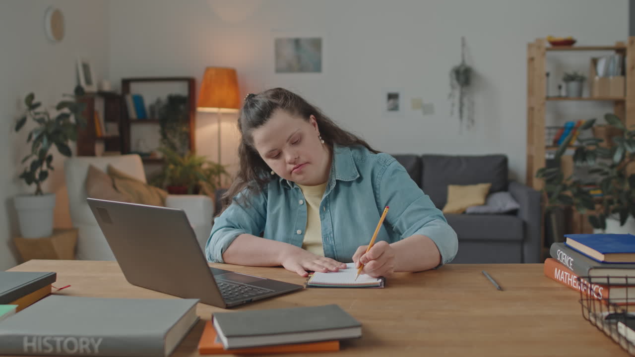 Woman with Down Syndrome Studying at Home