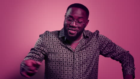 African-american-guy-making-movements-in-studio.-Enthusiastic-guy-dancing-indoor