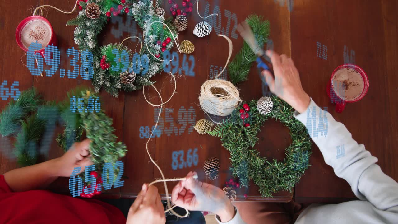 Two women grabbing twine and scissors, measuring, placing berries, trimming, completing DIY wreaths