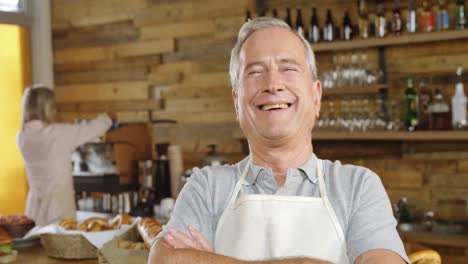 Smiling-waiter-in-cafe-4k