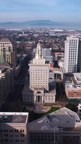 Vertical-Aerial-View,-Oakland-City-Hall-and-Downtown-Buildings,-California-USA