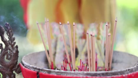 incense sticks slowly burning down in holder