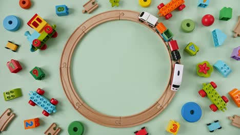 childish toy wooden railway. child's train rides on the ring railway. nursery playroom. top view. copy space