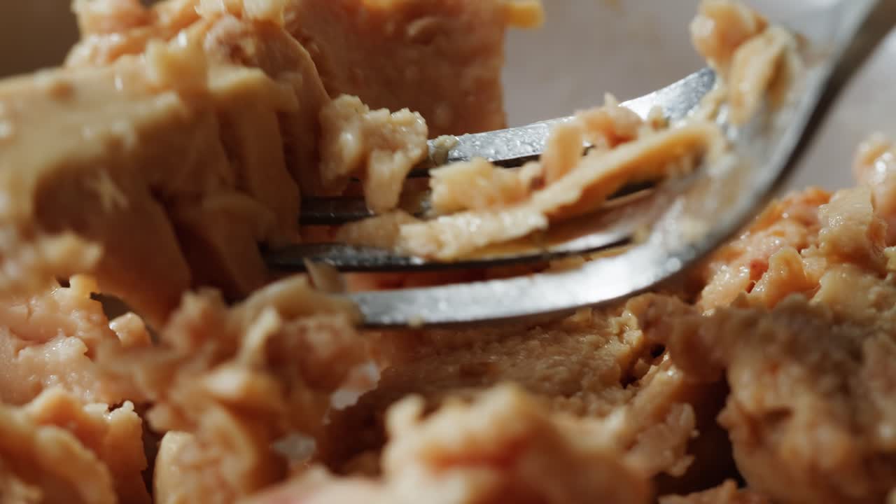 Smoked cod liver in oil in open tin can with fresh greens on wooden table. Seafoods delicacy. High quality 4k footage