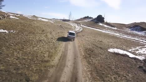 van driving on a mountain dirt road