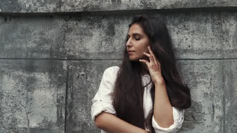 woman with henna tattoo by wall