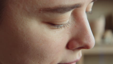 female artist sculpting head out of clay