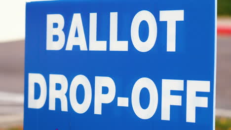 blue ellection ballot drop-off sign blowing in the wind outside close up