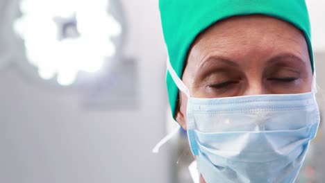 female nurse in surgical mask at operation theater