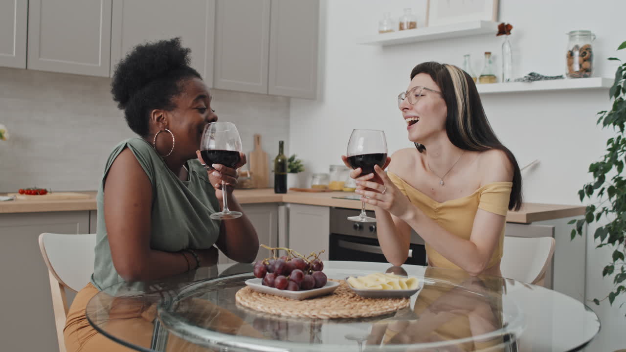 Happy Female Couple Chatting and Enjoying Wine