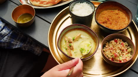 indian meal with soup, rice, and salad