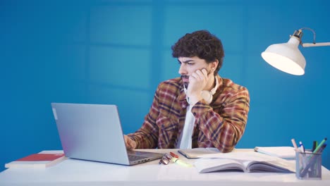 Thoughtful-and-confused-male-student-studying-using-laptop.