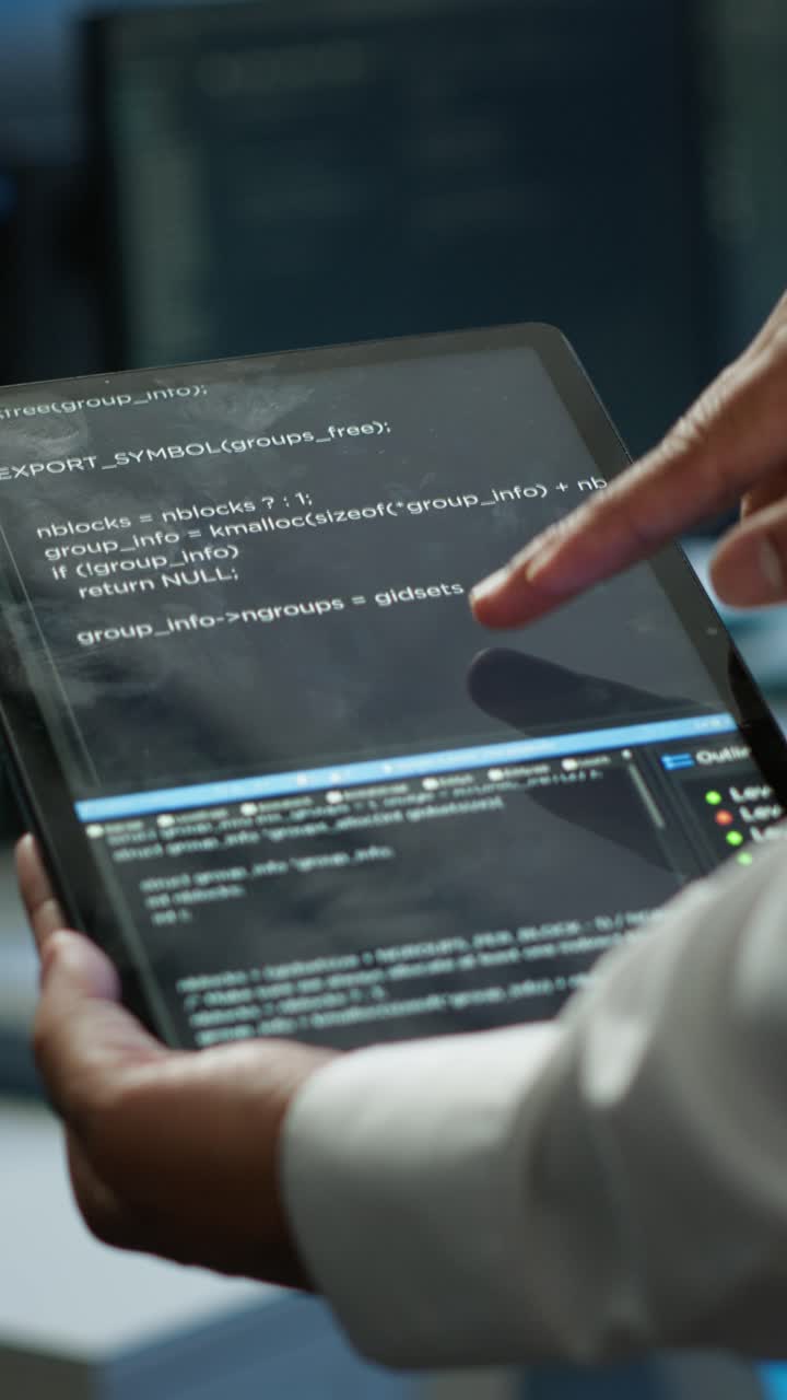 Female Programmer Working with Code on Tablet and Computer
