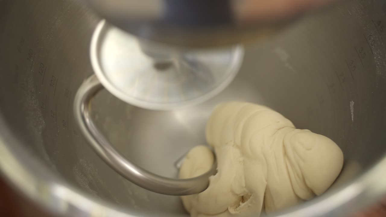 Bread Dough Preparation with Electric Mixer in Stainless Steel Bowl, Close Up