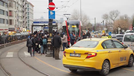 busy city street scene with tram and taxi in istanbul