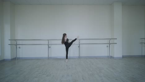 young ballet girl at studio lesson. training performance. stretching exercise pose. ballerina practice balance technique. classical elegance fitness.