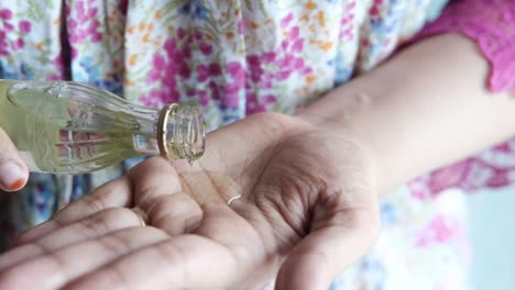 applying herbal oil to hand