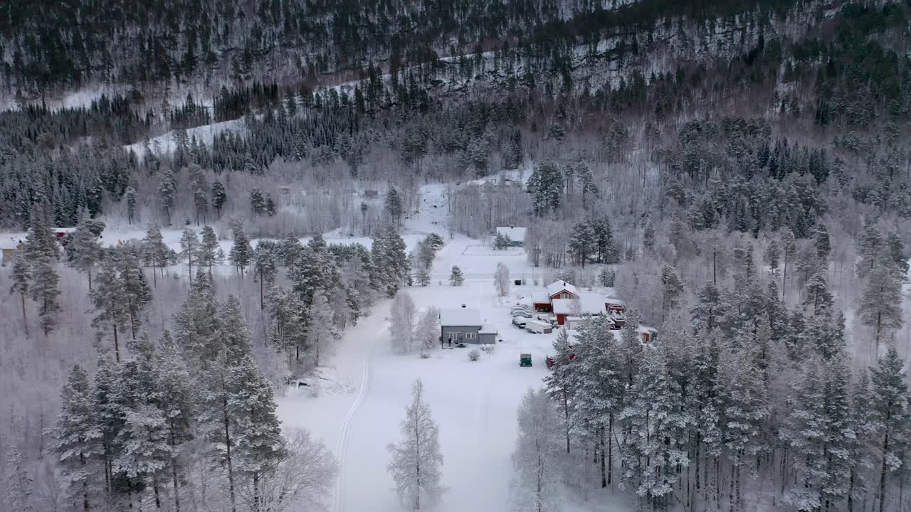 Norway’s winter wilderness in 4K: Drone footage of Arctic beauty. Snowy, cinematic, and mesmerizing. tiny houses in the middle of snowy magic.