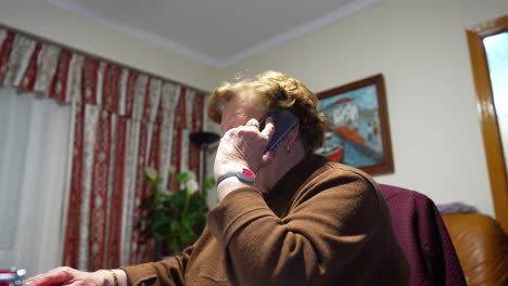 granny with health bracelet talking on phone with doctor asking for advice