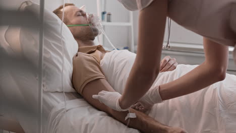 nurse putting drip on sleeping patient