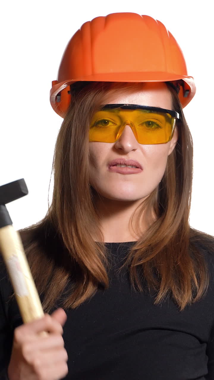 Young smiling Worker woman. Isolated over white background. Construction and maintenance. Vertical video