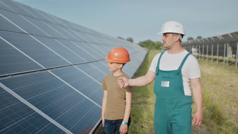 father and son inspecting solar panels